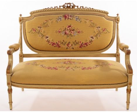 An upholstered salon suite, the parcel gilt frames green painted with gilded ribbon ties to the backs, on fluted taper legs, 