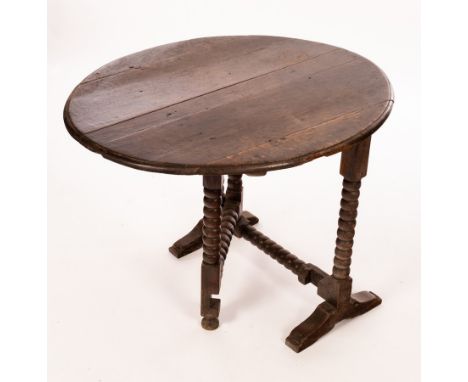 A Charles II oak coaching table, with oval tip-up top on bobbin turned legs and stretchers, 76.25cm wide  CONDITION REPORT: C