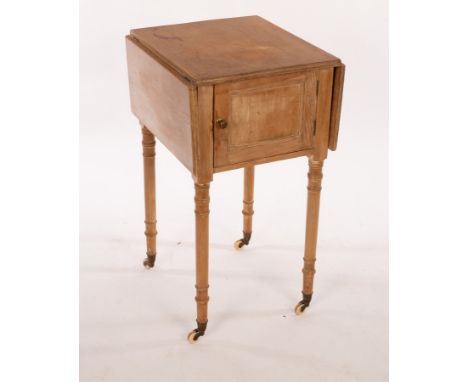 A pine two-flap bedside cupboard on turned legs, 46cm wide CONDITION REPORT: This item has been stripped in the past, the doo