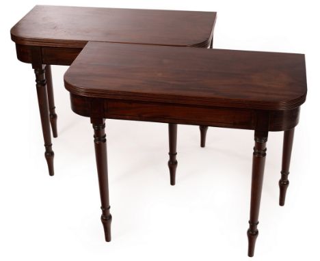 A pair of Regency mahogany fold-over card tables, each with baize lined playing surface and on turned legs, ebony line inlays