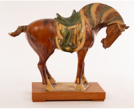 A Chinese sancai glazed horse on plinth, 20th Century, the brown glaze horse with yellow and green glaze saddle, 32cm high CO