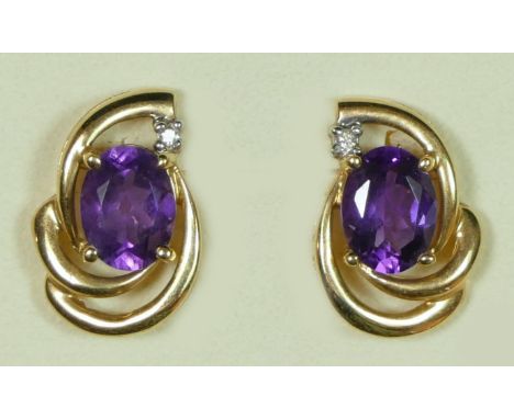 A 9ct gold pair of amethyst and diamond scroll ear studs, 3.6gm 