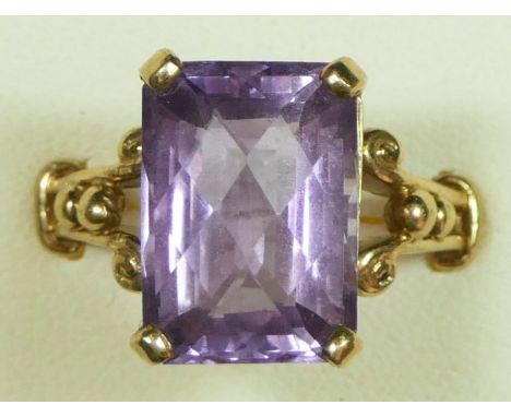 A 9ct gold amethyst dress ring, claw set with a multi-faceted rectangular stone, 14 x 10mm, ornate shoulders, N, 5.1gm 