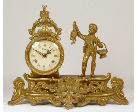 An Italian brass 8 day mantel clock, the eight day clock with boy holding a fish, raised on a scroll base, German Franz Herml