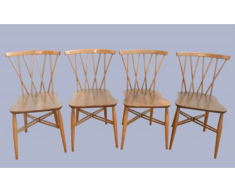 A set of four Ercol beech and elm candlestick chairs, c.1960s, model 376, having crossed spindle backs, saddle seats supporte