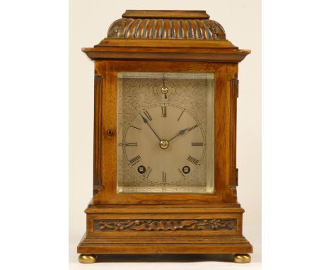 A late 19th Century German walnut 8 day bracket clock, the silvered dial with Roman numerals and fast/slow dial, the movement