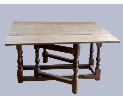 A late 17th century oak gate leg table, with associated rectangular plank top, raised on baluster legs, joined by stretchers,