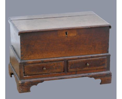 An 18th century oak joined oak Welsh coffer Bach, of small proportions, with moulded lid over a plain front, two short drawer
