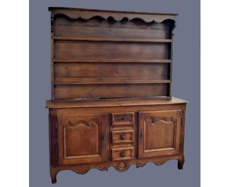 A good 18th century French ok dresser, believed Nancy/Metz region, with a three shelf rack with shaped frieze, the base with 