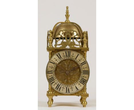 A late 19th Century brass lantern clock, the silvered dial with Roman numerals, the French movement striking on a bell - 24cm