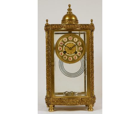 A 19th Century French brass four glass and gilt metal eight day mantel clock, with ornate cast detail, mercury, double pendul
