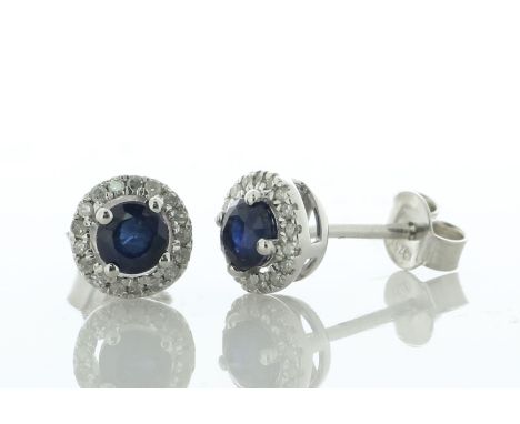 A charming pair of classic stud earrings, these 9ct white gold studs each have a deep midnight blue round sapphire surrounded