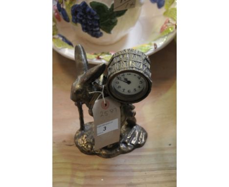 A Gilt metal hare figural timepiece,  the clock mounted in a barrel carried  on the back of a travelling hare.