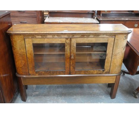 A 19th Century and later walnut cabinet on stand, having two panelled cupboard doors enclosing single fixed shelf.