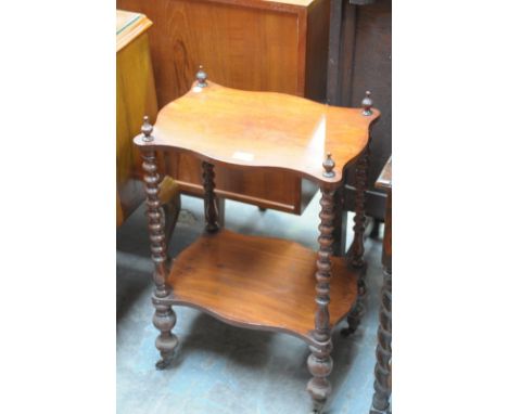 A Victorian walnut what not with bobbin turned supports.