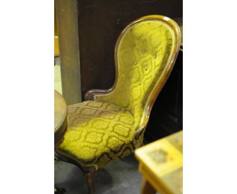 A Victorian rosewood drawing room chair 
The curvilinear waisted button back with a green leafy tapestry serpentine seat rais