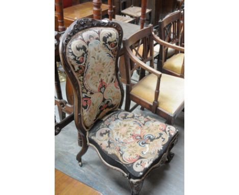 A Victorian rosewood drawing room chair with a padded tapestry back and seat.