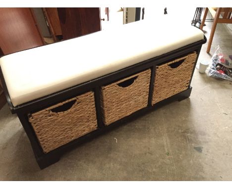 *A bench with wicker baskets for storage below.