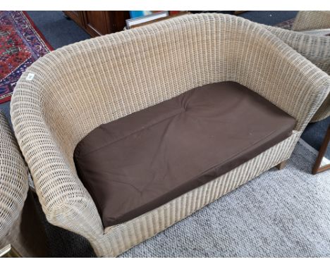 A three piece conservatory cane suite with matching stool 