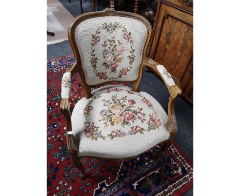 A walnut carved armchair with tapestry cover 