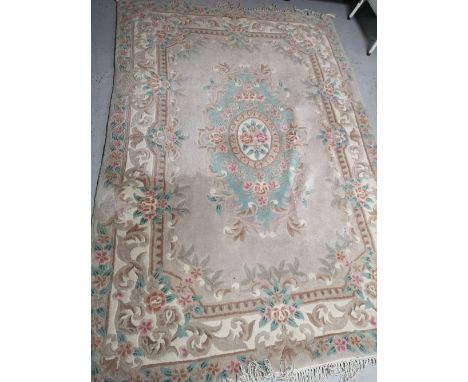 A fringed Chinese carpet, 270cm by 182cm