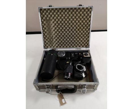 An olympus OM10 camera, two lenses, flash light and further Kodak Brownie 