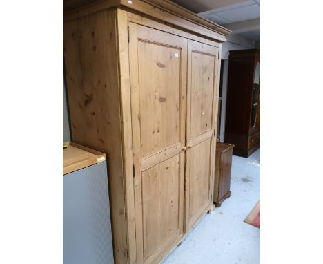 A traditional style pine double door wardrobe with interior shelf 