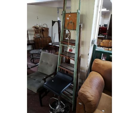 A set of metal steps, aluminium steps, wooden ladder and a bar stool 