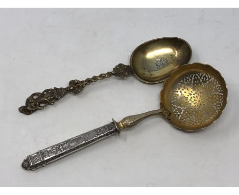 A 19th century silver strainer and a mid-Victorian silver gilt spoon dated 1856 (2)