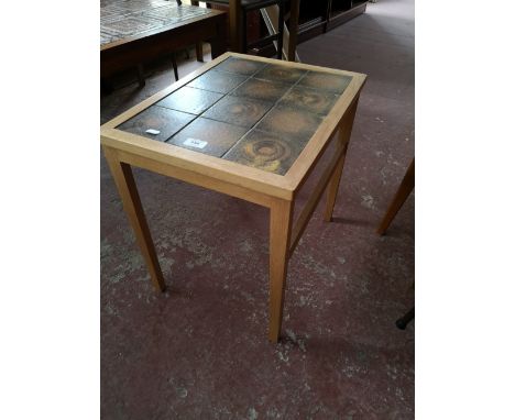 A light oak Scandinavian lamp table with tiled top. 