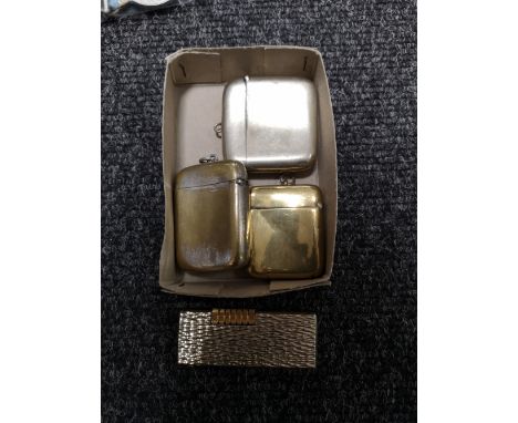A pocket lighter by Cosmic together with three metal vesta cases 