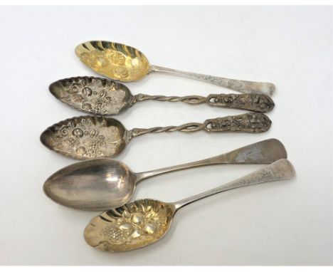 Two Georgian silver gilt repousse berry spoons, a Victorian silver table spoon and an ornate pair of berry spoons. (5)