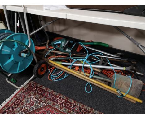 A quantity of garden tools, hedge cutter, electric strimmer, hose on reel etc 
