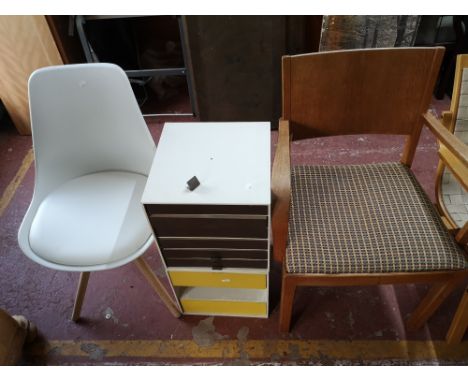 A light oak chair, an office multi drawer chest and a white chair.