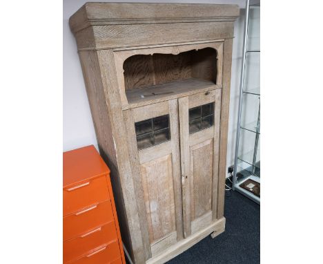 A continental light oak hall cabinet with glazed panel doors  CONDITION REPORT: 93cm wide by 188cm high by 47cm deep. 