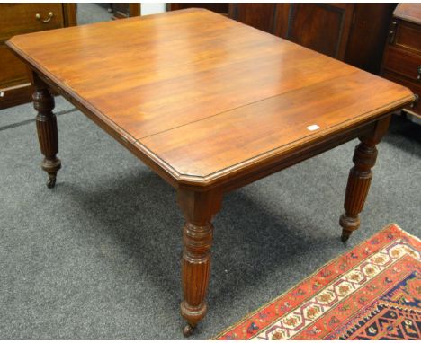 A Victorian mahogany windout dining table, rectangular top, canted angles, moulded edge, turned and reeded legs, ceramic cast