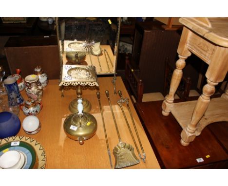 A brass mirrored firescreen; three brass fire irons; a brass kettle and a trivet stand