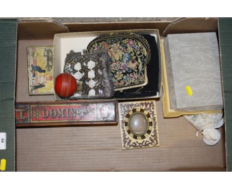 A box containing a dominoes set; three lady's evening purses; a novelty table lighter in the form of a cricket ball etc.