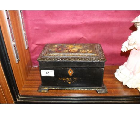A Victorian ebonised two compartment tea caddy with flora decoration