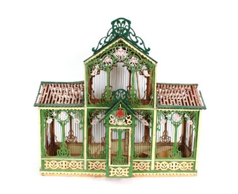 A wooden painted and decorated bird cage of architectural form 