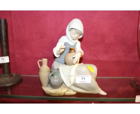 A large Lladro figurine in the form of a seated woman with pots