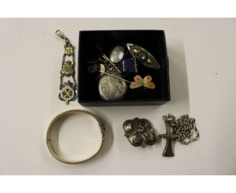 A small box containing silver and white metal jewellery to include a bangle, brooches, stick pins etc.