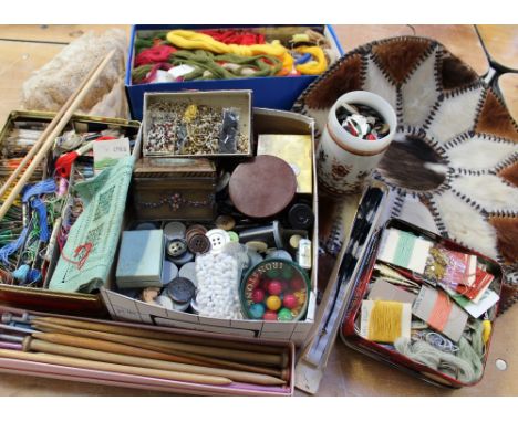 A quantity of vintage tins containing various sewing aids to include silk embroidery threads, beads, wool tapestry, two goat 