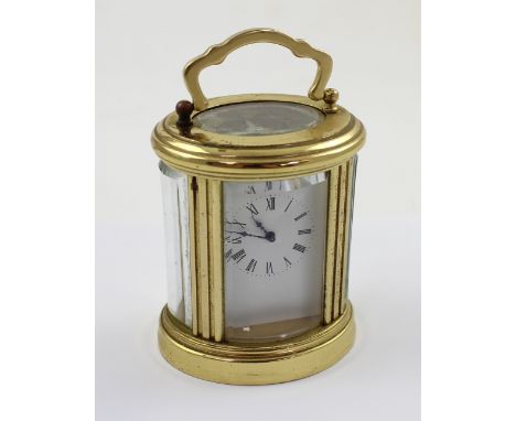 A miniature French brass carriage clock the enamelled dial set with Roman numerals, height 8cm.
