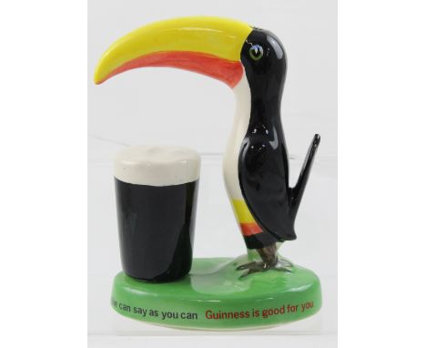 A Carltonware English stamp Guinness toucan lamp, featuring a toucan with pint of Guinness on green base with the legend 'How