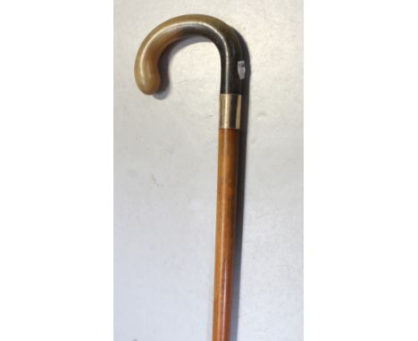 A collection of vintage walking sticks to include examples with horn handles, gold and silver coloured ferrules, a bamboo exa