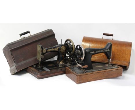 An oak-cased vintage Singer sewing machine and a similar mahogany-cased example, height of each approx 31.5cm (2).