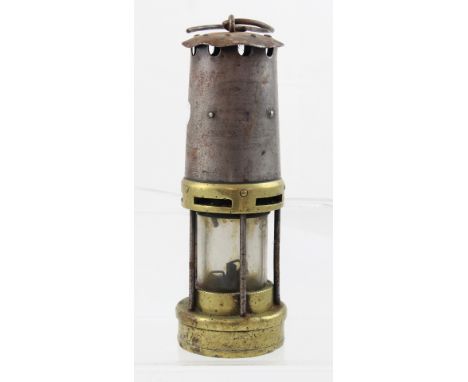 A Marsaut-style miners' lamp in brass and iron with cylindrical glass and electronic ignition, c1920, height 26cm.