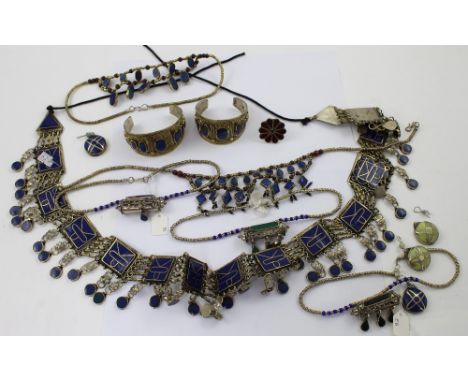 A quantity of white and yellow metal Afghan wedding and tribal jewellery to include bangles, a link chain belt set with lapis