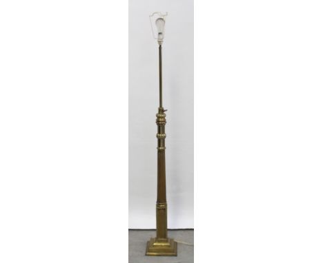 An early 20th century brass adjustable standard lamp with fluted column to square socle base, converted to electricity, heigh